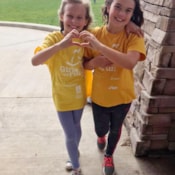 Girls on the Run participants make heart with their hands